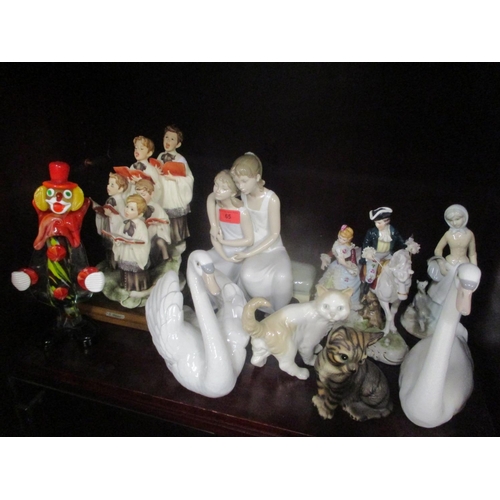 65 - A mixed lot to include two Lladro swans, Lladro figure group of two seated girls, a Murano clown and... 