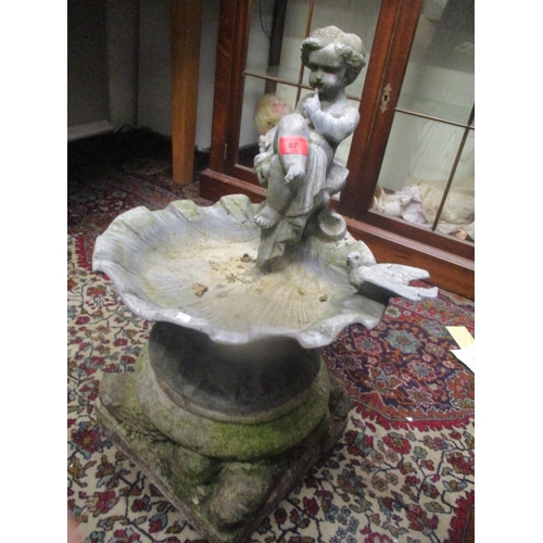 67 - A garden ornament of girl on a bird bath, possibly lead, on a stoneware base
Location: G