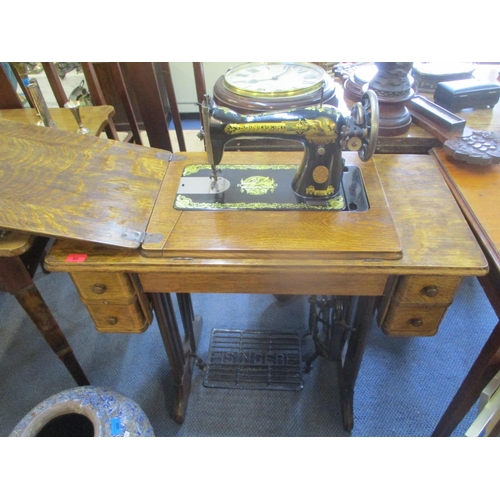 80 - An early 20th century oak Singer sewing machine table with inset sewing machine
Location: RAM