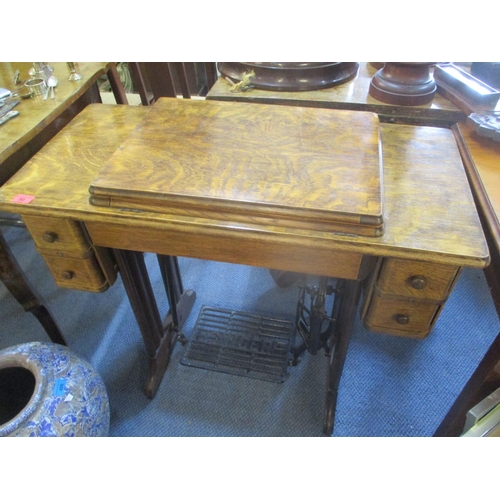 80 - An early 20th century oak Singer sewing machine table with inset sewing machine
Location: RAM