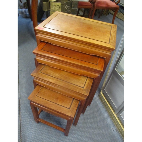 81 - A modern Oriental rosewood nest of four tables 27