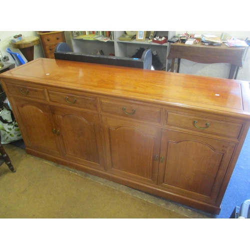 86 - A modern Oriental rosewood sideboard having four drawers, cupboards and on a plinth base 34