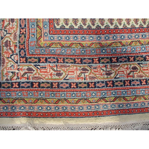 104 - An Indian carpet with repeated boteh on a cream ground within a red, blue and yellow border 100