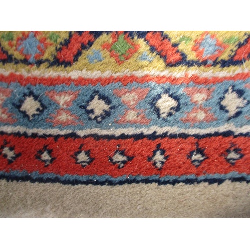 104 - An Indian carpet with repeated boteh on a cream ground within a red, blue and yellow border 100