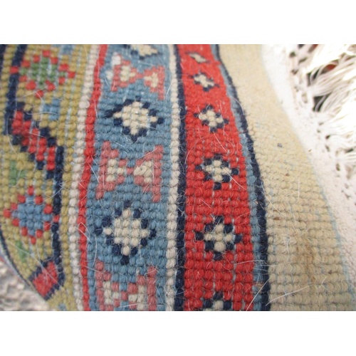 104 - An Indian carpet with repeated boteh on a cream ground within a red, blue and yellow border 100