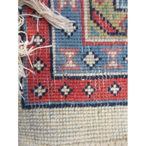 80 - An Indian carpet with repeated boteh on a cream ground within a red, blue and yellow border, 100 x 1... 