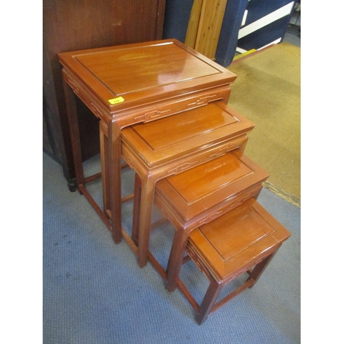 224 - A nest of four Chinese rosewood tables, the largest 26