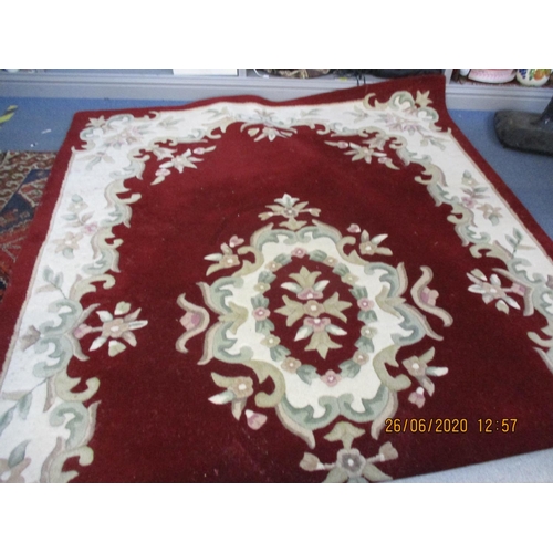 104 - A red and cream ground Chinese carpet, 71