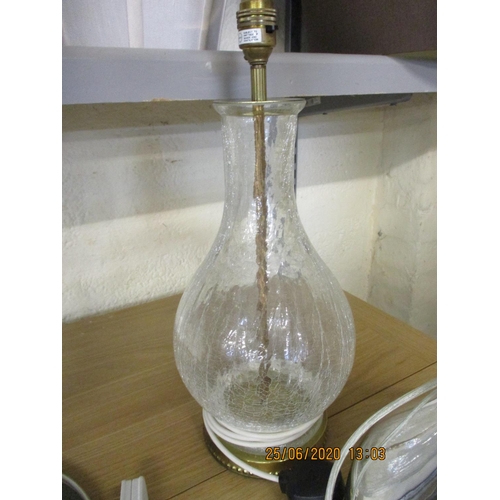 21 - A crackle glass table lamp with central brass rod and two others, together with various lamp shades
... 