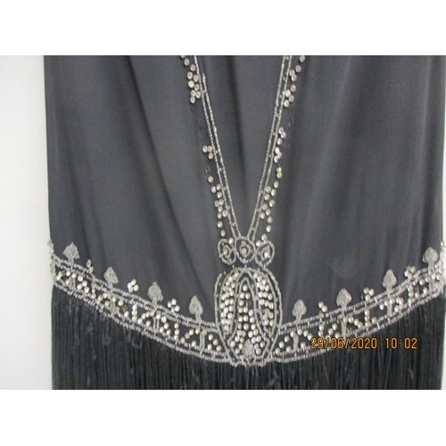 34 - A 1920s black Charleston dress with diamante bead detail having a black fringe, measurements approxi... 