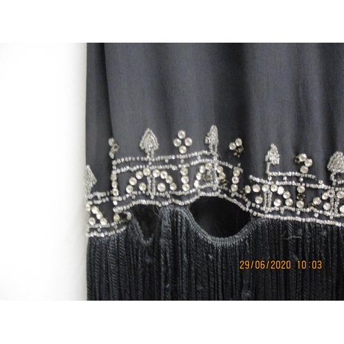 34 - A 1920s black Charleston dress with diamante bead detail having a black fringe, measurements approxi... 