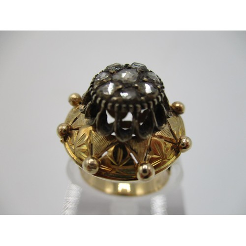 45 - A 18th century gold coloured metal and diamond ring, the domed top set with eight old mine cut diamo... 