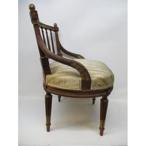 295 - A late 19th Century Louis XVI style walnut and gilt salon chair with a wreath carved crest, a spindl... 