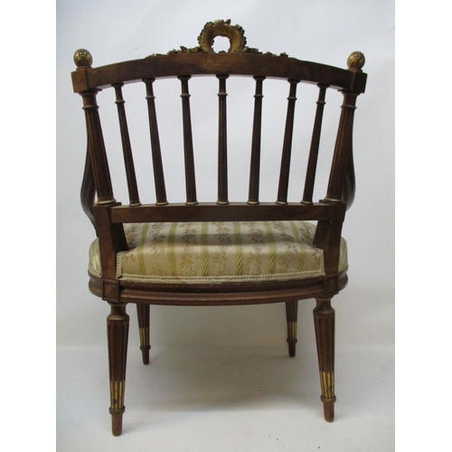295 - A late 19th Century Louis XVI style walnut and gilt salon chair with a wreath carved crest, a spindl... 