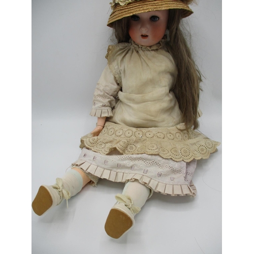 215 - An early 20th century German bisque headed doll stamped A.75 with closing eyes, open mouth and joint... 