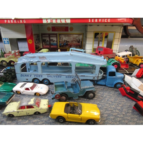 A tin plate vintage model garage with various Dinky Matchbox and other diecast model vehicles incl