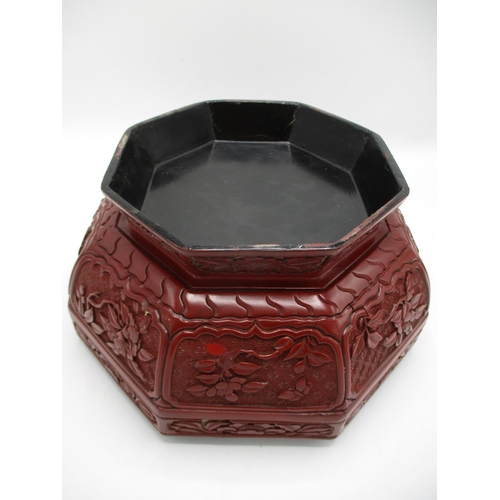 24 - A large 19th century Chinese cinnabar box of octagonal form, the domed lid decorated with panels of ... 