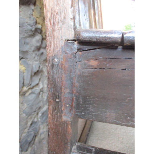 270 - A 17th/18th century oak Wainscot chair with a carved crest, panelled back, scrolled arms and planked... 