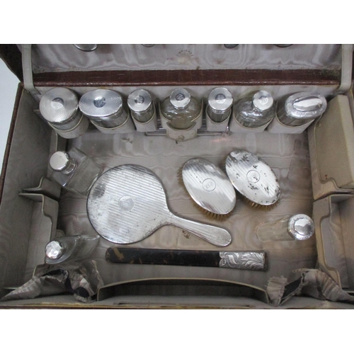 281 - !!!THIS LOT HAS BEEN WITHDRAWN!!!

An early 20th century crocodile vanity case with silver lidded gl... 