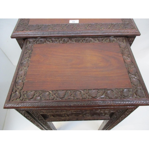 43 - A nesting set of three early 20th century Anglo Indian carved hardwood occasional tables with vine a... 