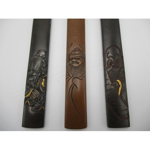 99 - A group of three Japanese Katana Kozuka fittings, of mixed metals, the copper one signed, the other ... 