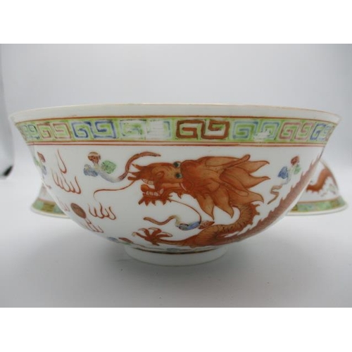 21 - Three early 20th century Chinese bowls decorated with a phoenix, a dragon and clouds, in polychrome ... 