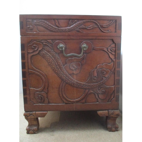 46 - An early 20th century Chinese hardwood chest, the top, front and sides carved with dragons and cloud... 