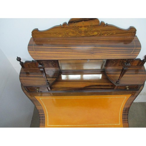 282 - A late 19th century Amboyna and Marquetry writing table with scrolled leaf, ribbon and urn ornament,... 