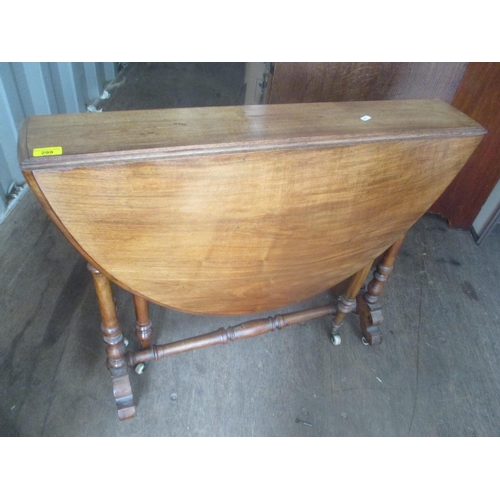 67 - A Victorian walnut Sutherland table having turned columns and standing on castors, 71
