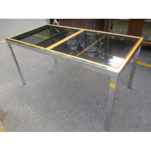 69 - A modern chrome and glass topped extending dining table, 76 1/2