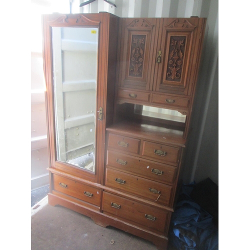 70 - A late Victorian walnut wardrobe having a single mirrored door, two carved cupboard doors and eight ... 