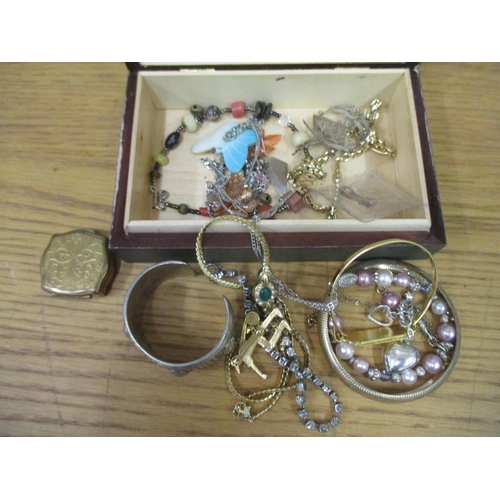 128 - A small mixed group of costume jewellery and silver to include a heavy white metal bangle, Trifari b... 