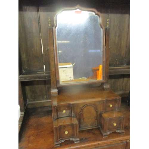 181 - An early 20th century walnut dressing table mirror above four drawers flanking a central cupboard do... 
