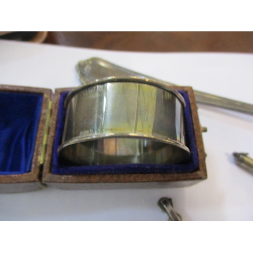 256 - A quantity of small silver items to include a cased napkin ring, a 1922 silver dollar, mounted with ... 