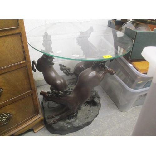 301 - A bronzed finished resin occasional table in the form of three horses with a circular glass top abov... 