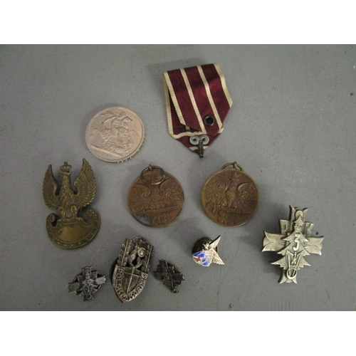 152 - A group of Polish medals shouldered badges and others, along with a 1951 crown
Location: TABLE