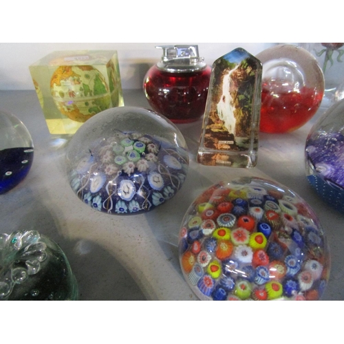 155 - A collection of paperweights and a table lighter to include Strathearn and an Isle of Wight paperwei... 