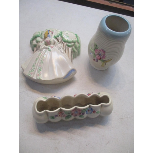 166 - Clarice Cliff items comprising a posy trough, a vase and a wall pocket
Location: 11.1