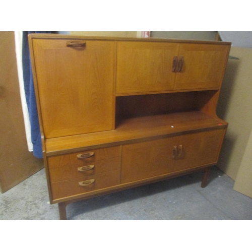 2 - A 1970's E Gomme G Plan Fresco highboard having twin cupboard doors and pull down with internal shel... 