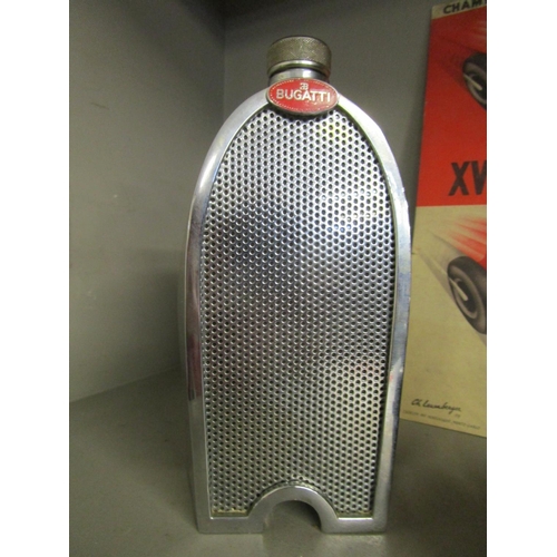 209 - A selection of motor racing memorabilia to include a flask in the form of a Bugatti car radiator, a ... 