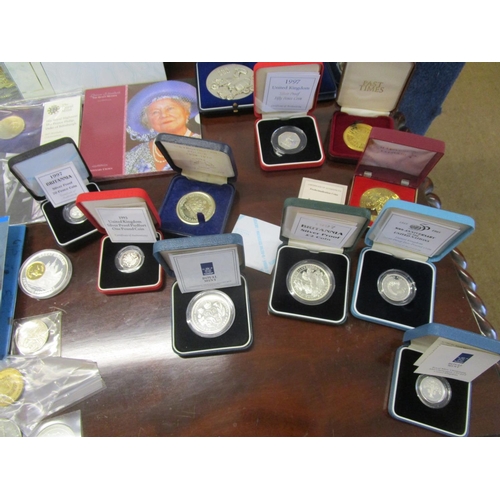 214 - A collection of cased silver proof coins, coin sets, medals and other commemorative coins to include... 