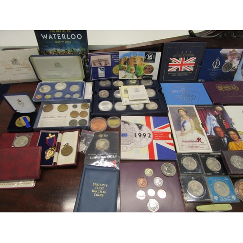 214 - A collection of cased silver proof coins, coin sets, medals and other commemorative coins to include... 