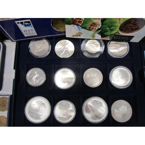 214 - A collection of cased silver proof coins, coin sets, medals and other commemorative coins to include... 