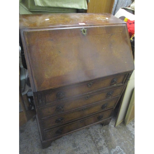 242 - An early 20th century walnut bureau having a fall flap above four drawers and bracket shaped feet 10... 