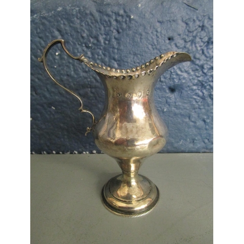 5 - A George III silver cream jug, London hallmarks, makers mark GG and a pair of silver embossed pen tr... 
