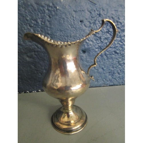 5 - A George III silver cream jug, London hallmarks, makers mark GG and a pair of silver embossed pen tr... 