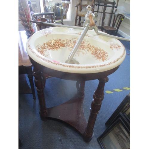 71 - An early 20th century mahogany and ceramic bedroom sink 83cm h x 59cm w
Location: FSR