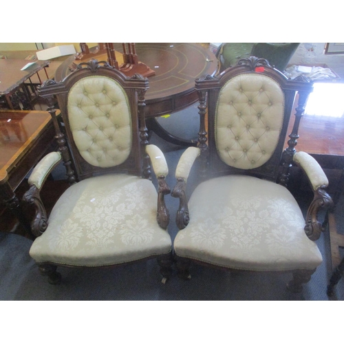 73 - A pair of Victorian mahogany button back salon armchairs having scroll shaped arms, fluted columns a... 