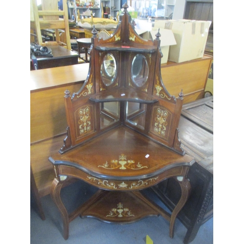 83 - An Edwardian walnut Sheraton revival corner stand having a raised mirrored back and urn and floral s... 