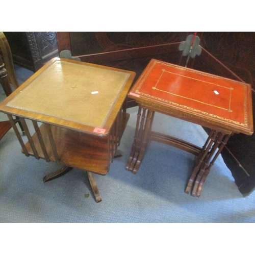 84 - A reproduction mahogany swivel topped table having a leather top and four splayed legs, together wit... 